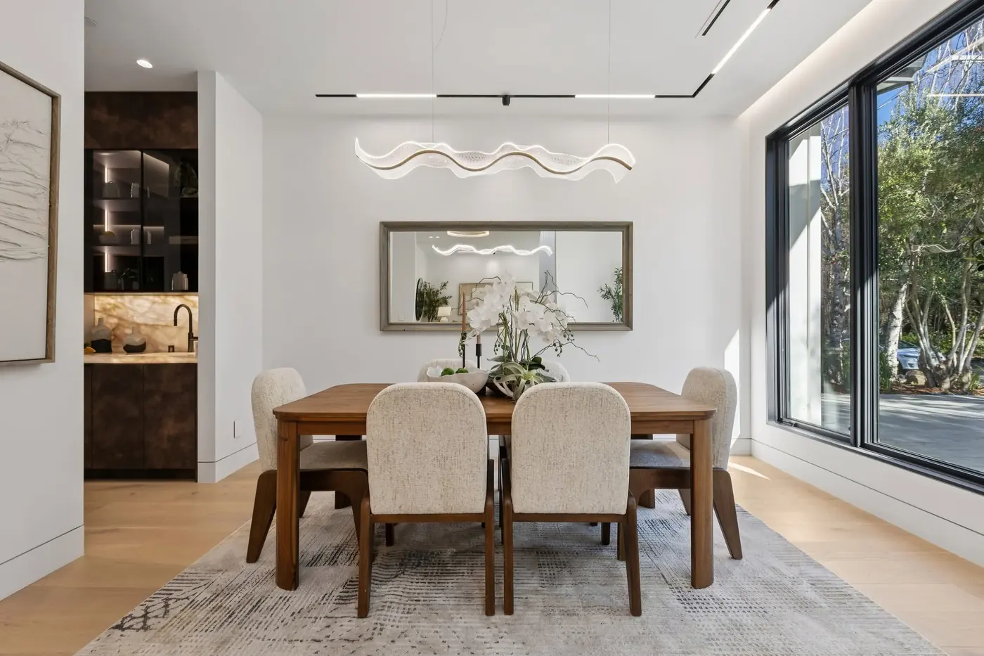 Dining table under a sculpted pendant