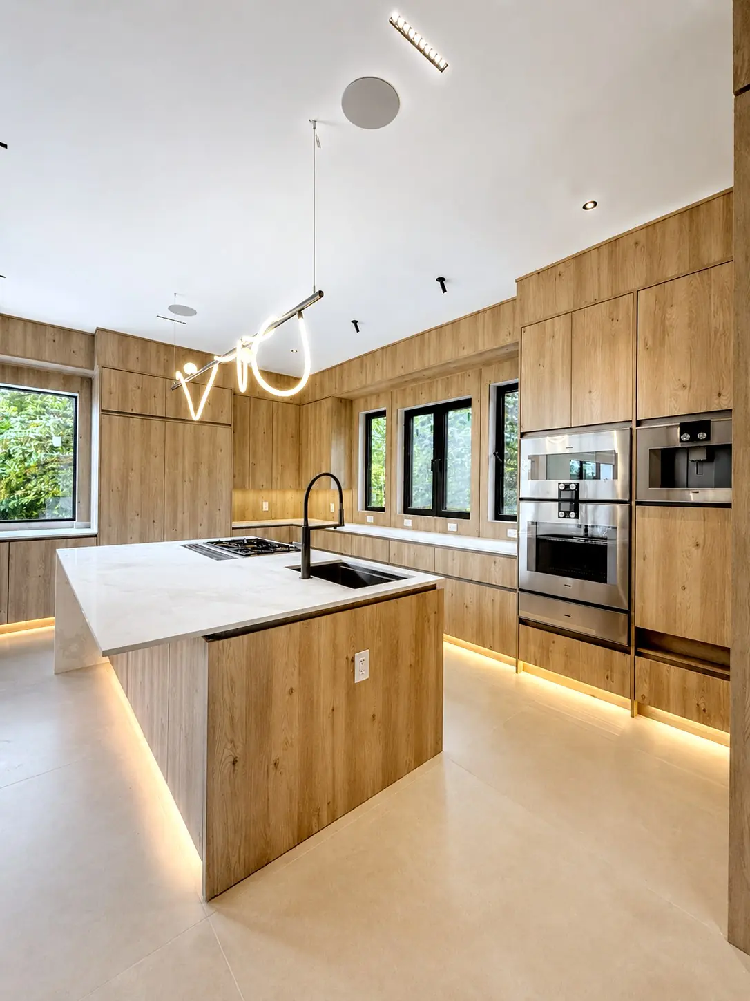 Kitchen island with a lit plinth and under cabinet light