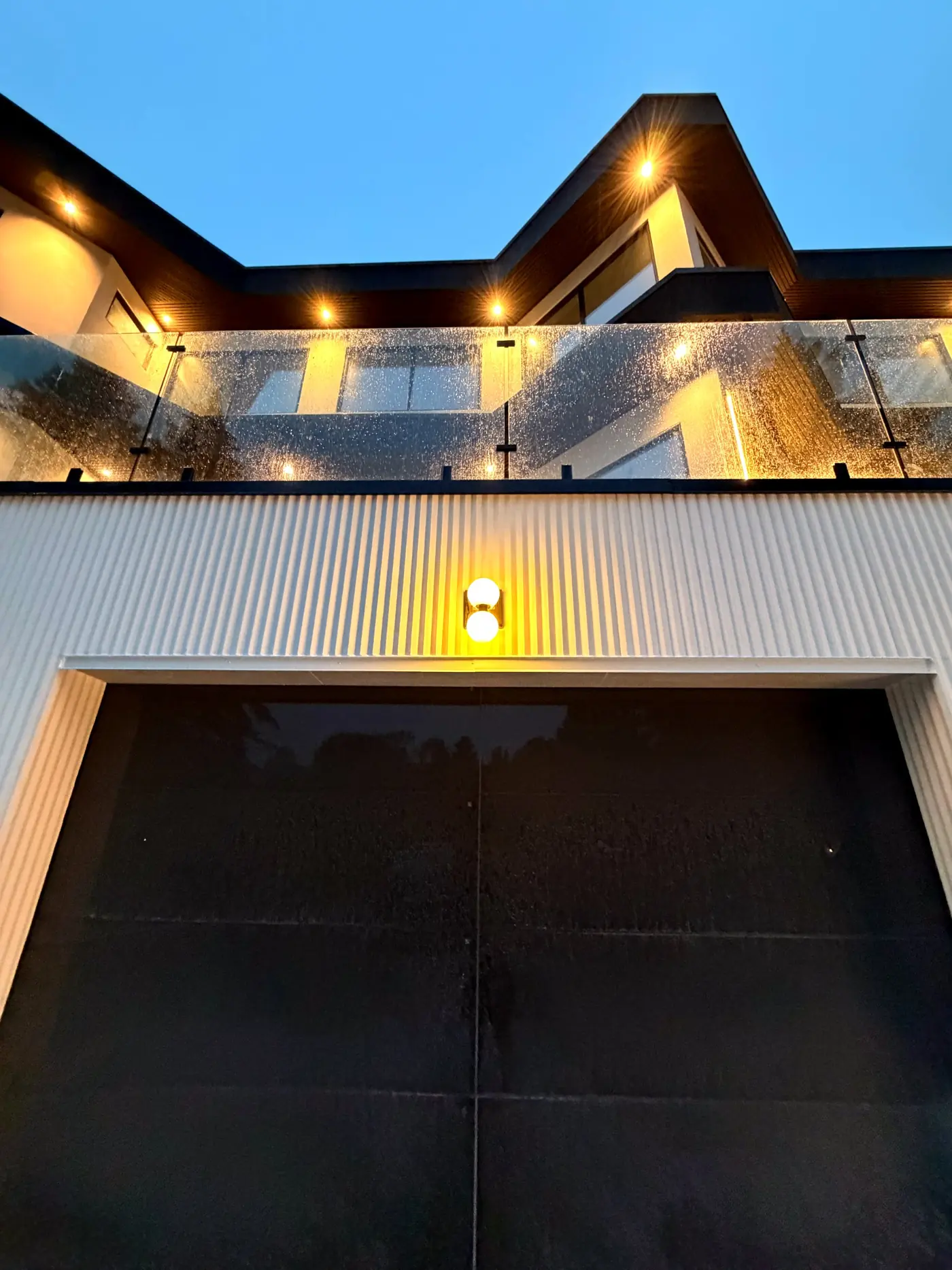 Soffit lighting picking out the underside of the cantilever at dusk
