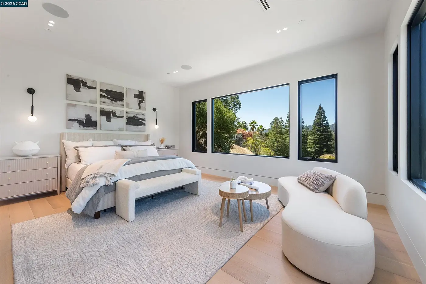 Bedroom with a seating corner and recessed downlights